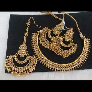 Indian jewelry with tikka, necklace, and earrings.